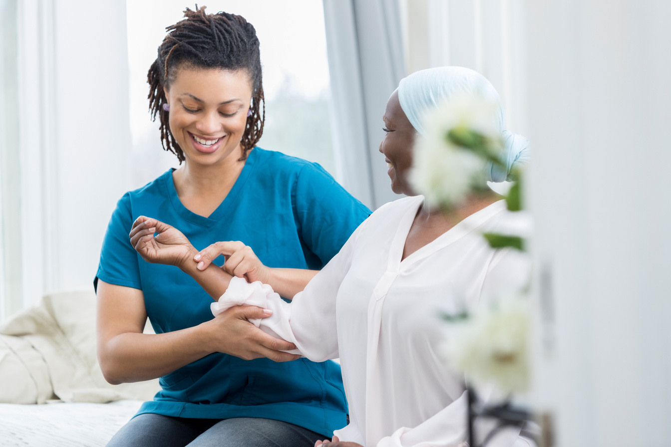 Home healthcare nurse checks patient's vital signs